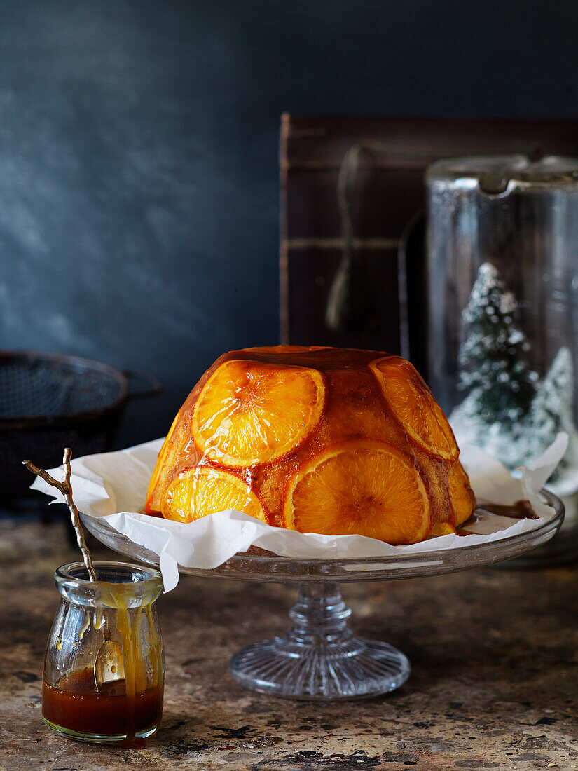 Orange pudding with rum syrup sauce