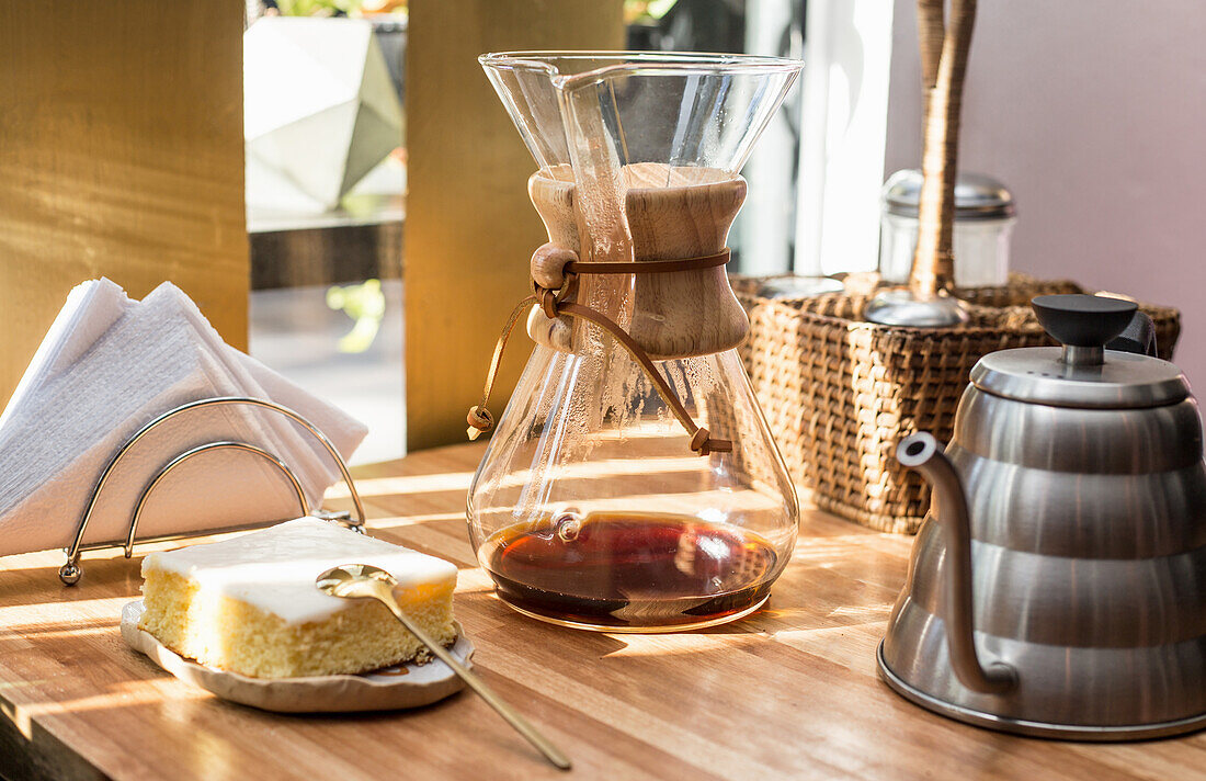 Chemex coffee carafe with a square of lemon cake