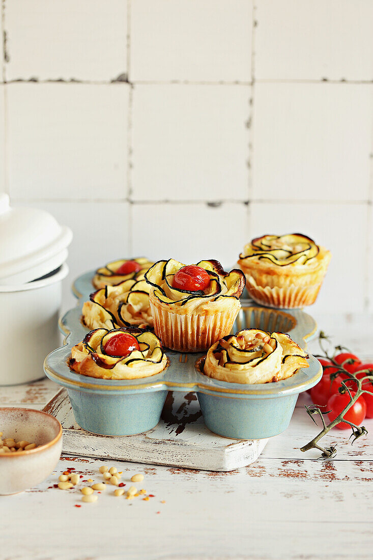 Individual Puff pastry tartlets with zucchini, cherry tomatoes, cream cheese, and pine nuts