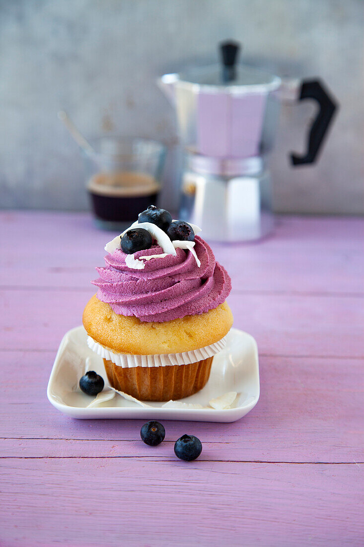 Cupcakes with blueberry topping and coconut shavings