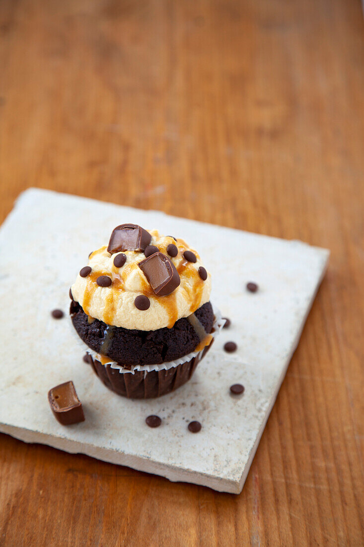 Chocolate cupcakes with caramel topping and toffee pralines