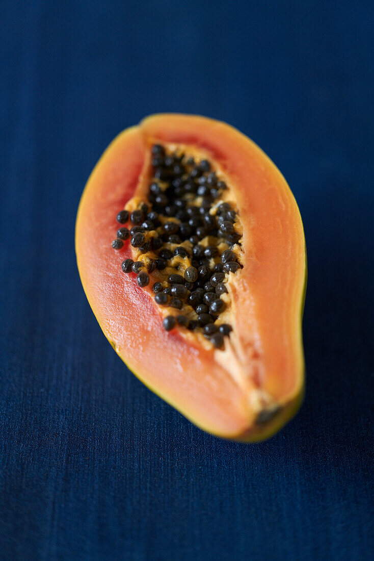 Papaya half on a blue background