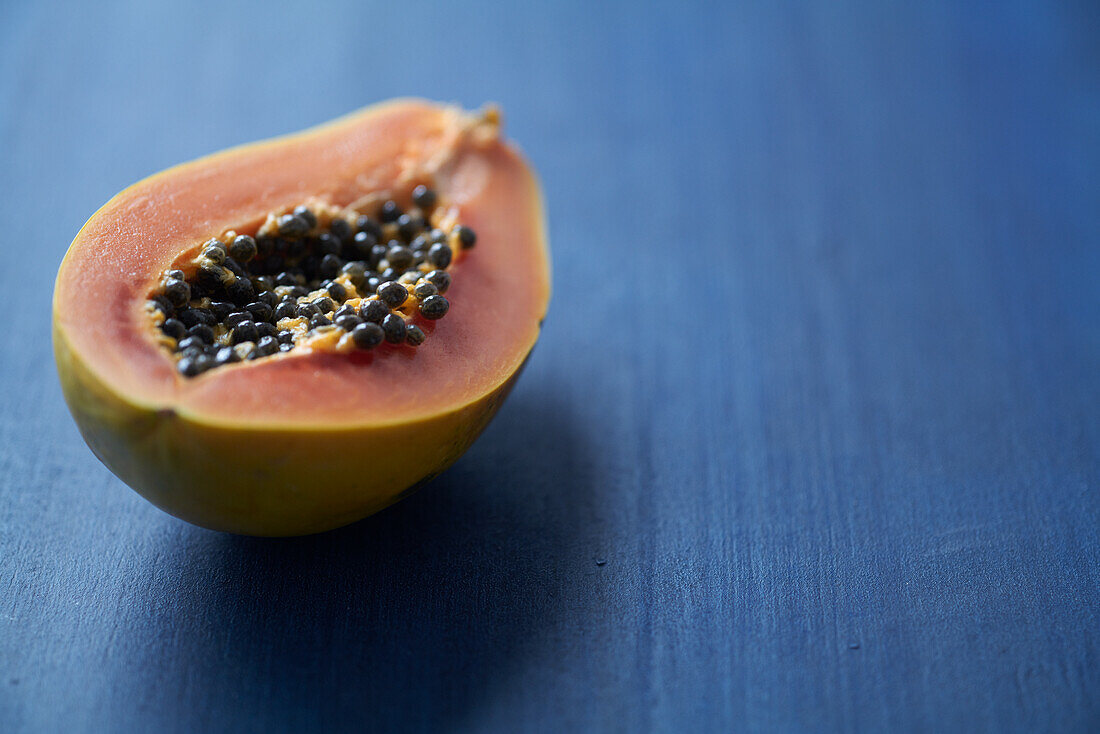 Papaya half on a blue background