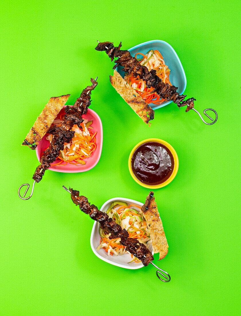 Vegan barbecue skewers with BBQ sauce, salad, and grilled bread