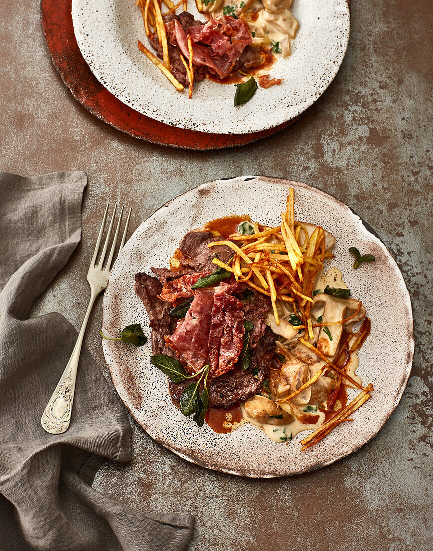 Venison saltimbocca with Marsala sauce, creamy porcini mushrooms and straw potatoes