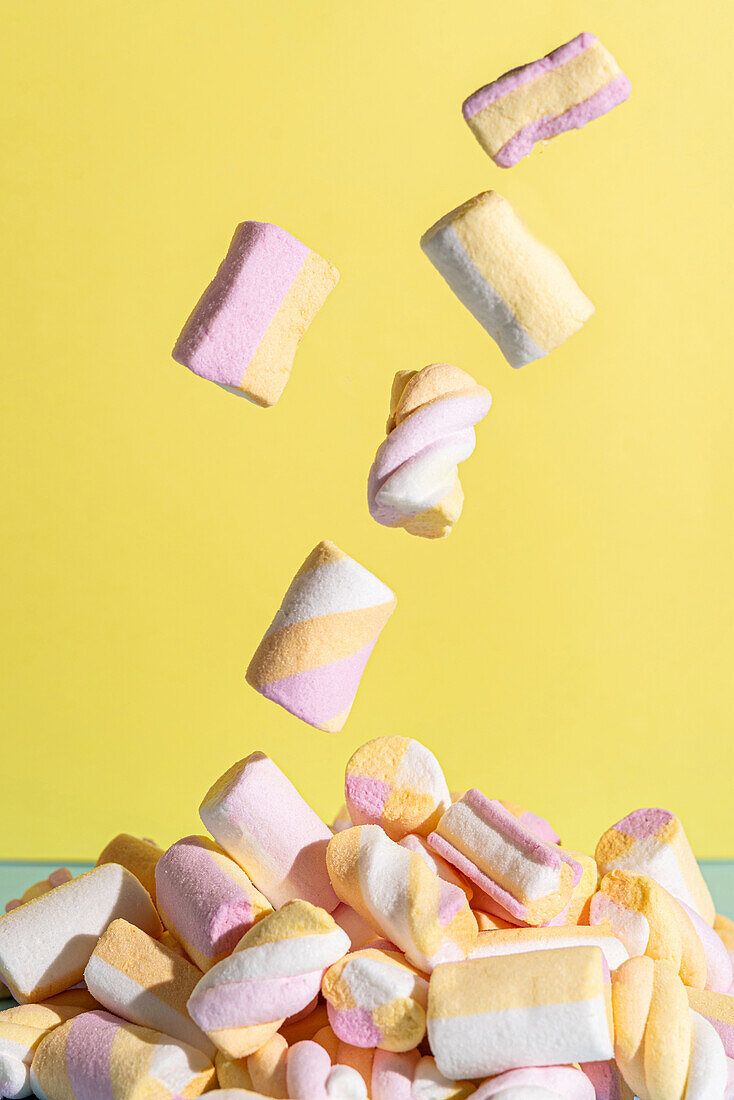 Falling marshmallows on a yellow background