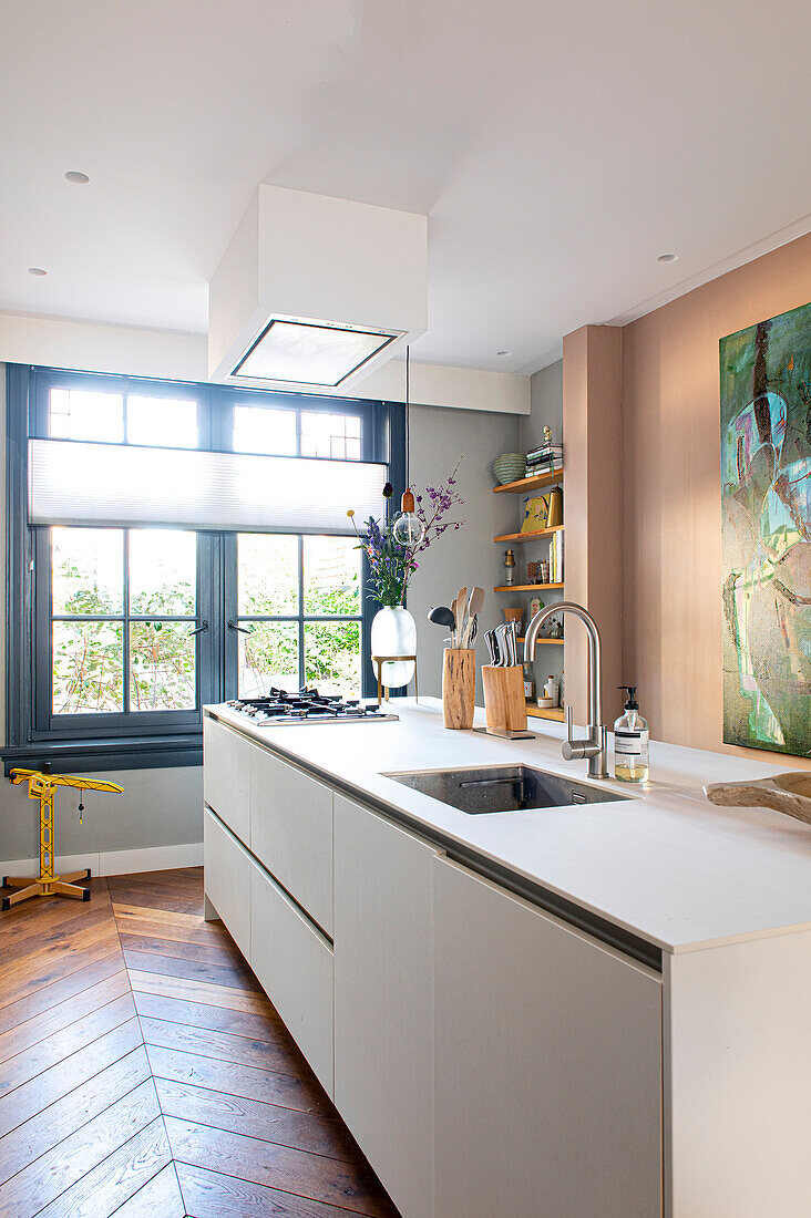 Kitchen with white cabinets and counters and natural lighting