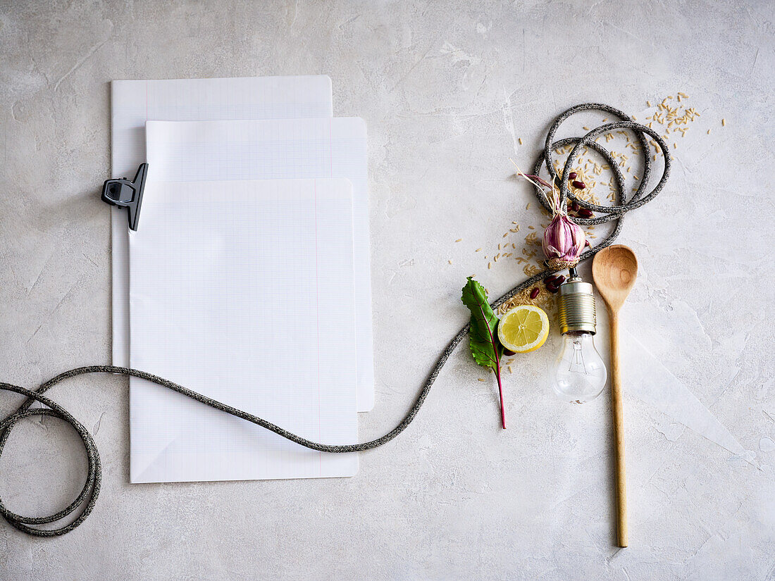 Blank paper, spices, vegetables, cooking spoon and light bulb