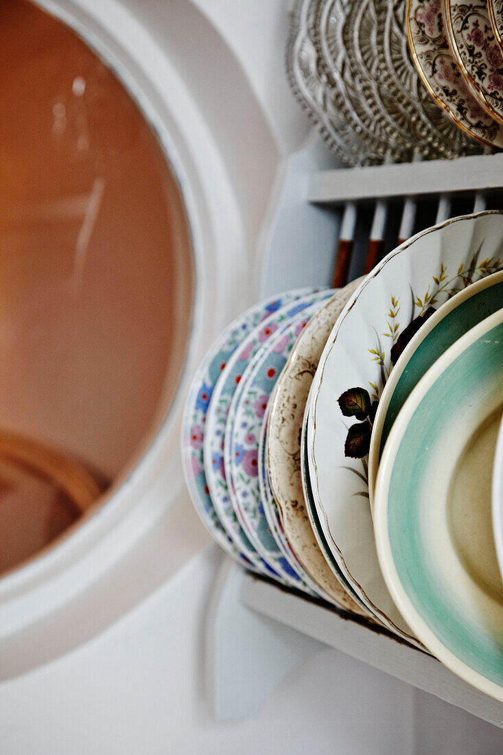 Variety of plates in a plate rack in Brighton, East Sussex, England, UK