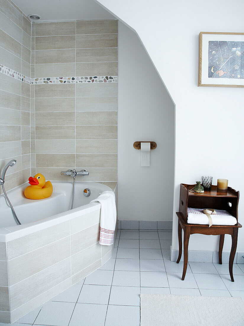 Tiled bathroom with corner bath