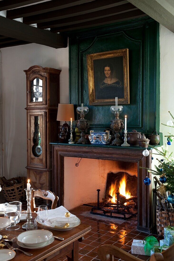 Living room with fireplace and dining table decorated for christmas