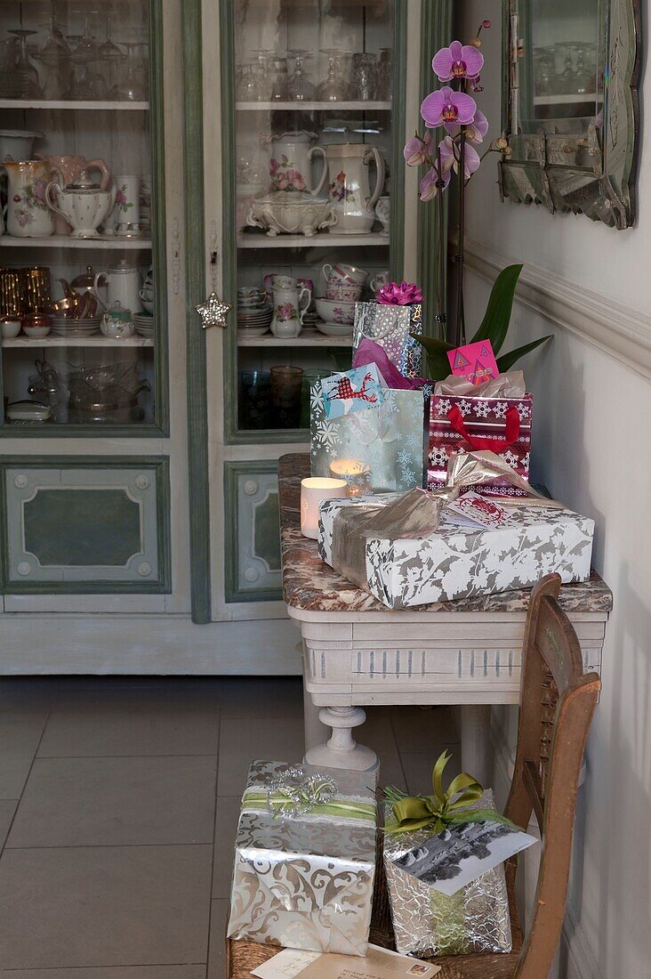 Christmas presents on small table in home