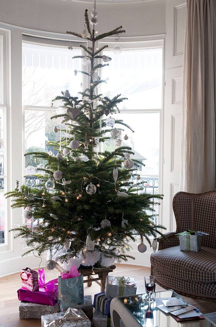 Christmas presents under tree in living room