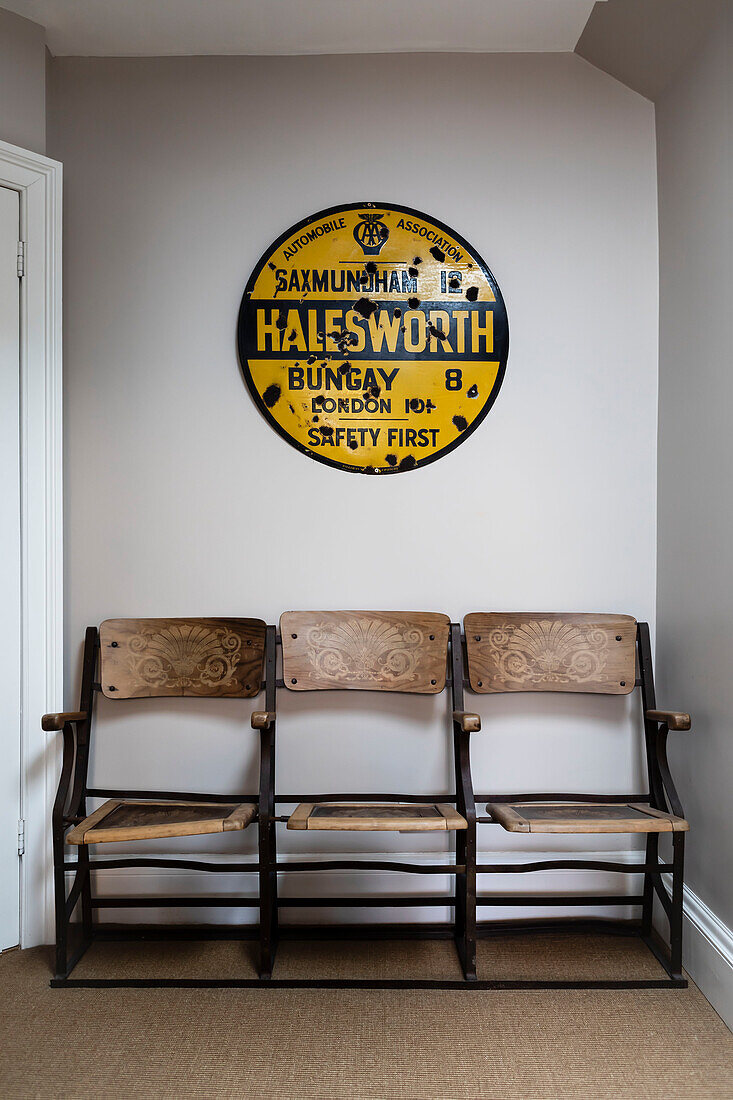 Reclaimed cinema seating and local road sign in Woodbridge home Suffolk UK