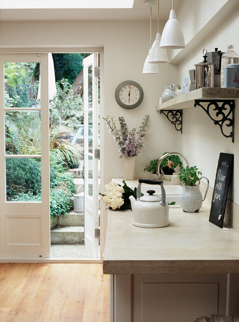 Kitchen utility room with open shelves and skylight