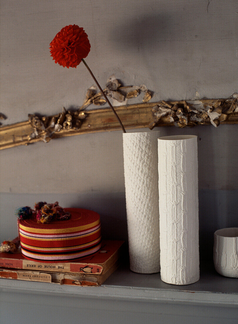 Grey mantelpiece with white ceramic vases and homewares