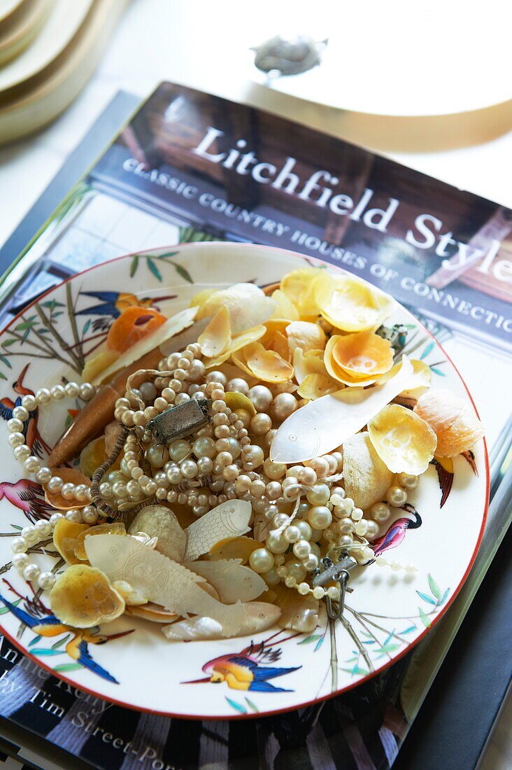 Seashells and pearls on decorative plate in Massachusetts home, New England, USA