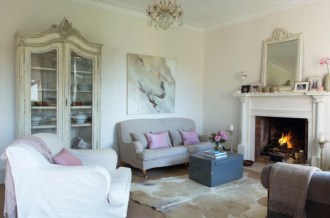 Glass fronted cabinet in seating area of Canterbury home England UK