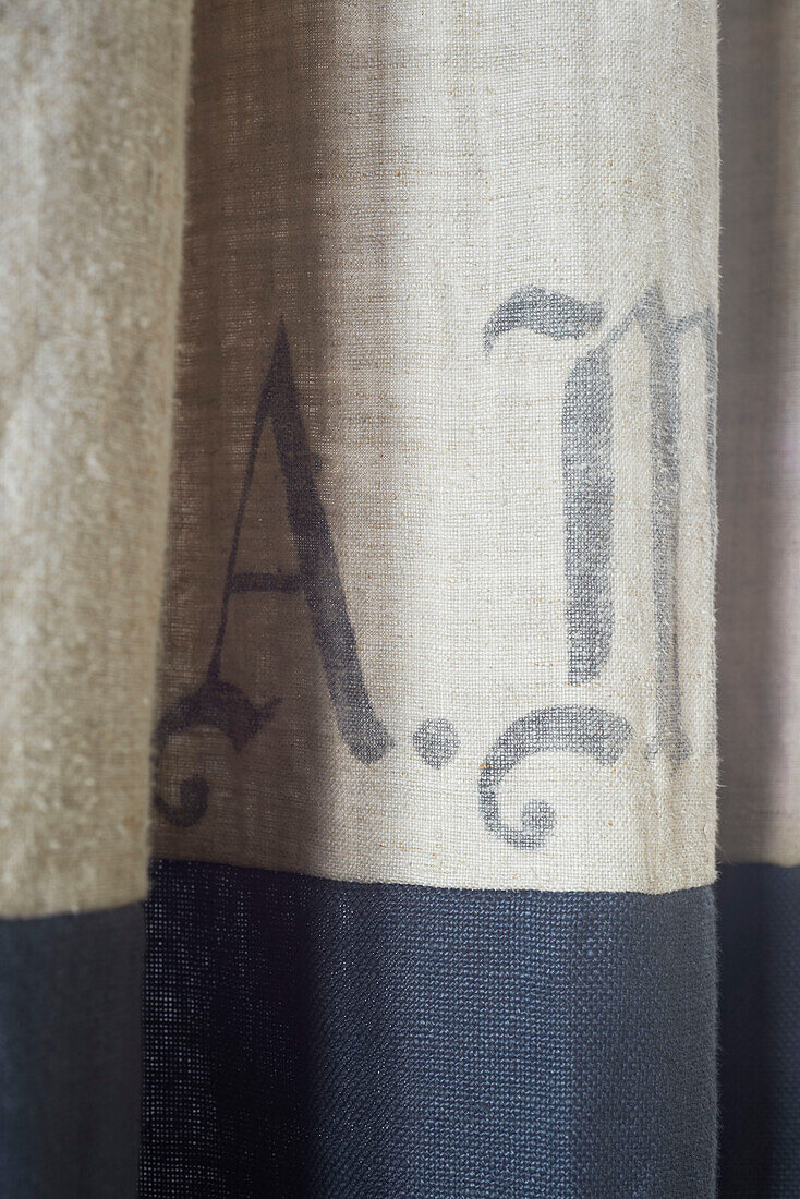 Letters 'A' and 'M' on hessian fabric in Hastings home, East Sussex, England, UK