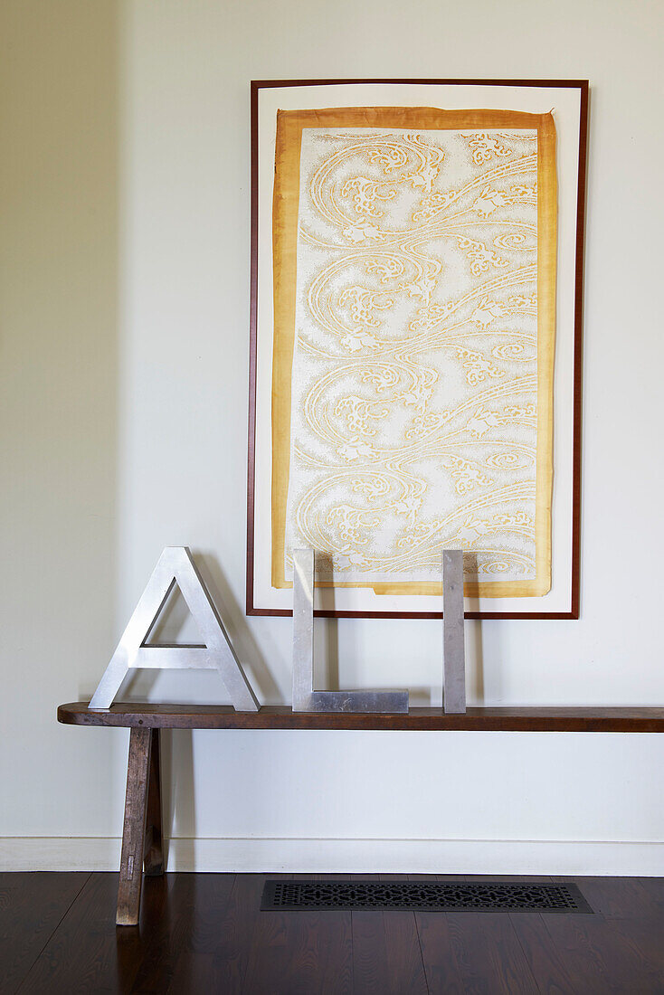 Metallic letters spell 'ALI' with patterned artwork and bench in Sheffield home, Berkshire County, Massachusetts, United States