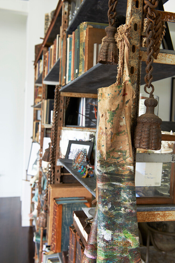 Rusty bells and apron on book shelves in Sheffield home, Berkshire County, Massachusetts, United States