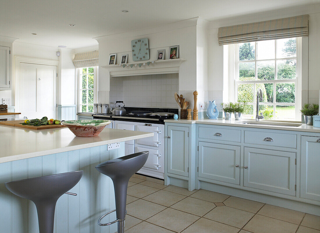 Light blue kitchen with recessed range oven in Lincolnshire country house, England, UK