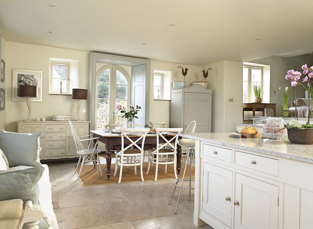 Kitchen table in open plan Gloucestershire farmhouse kitchen England, UK