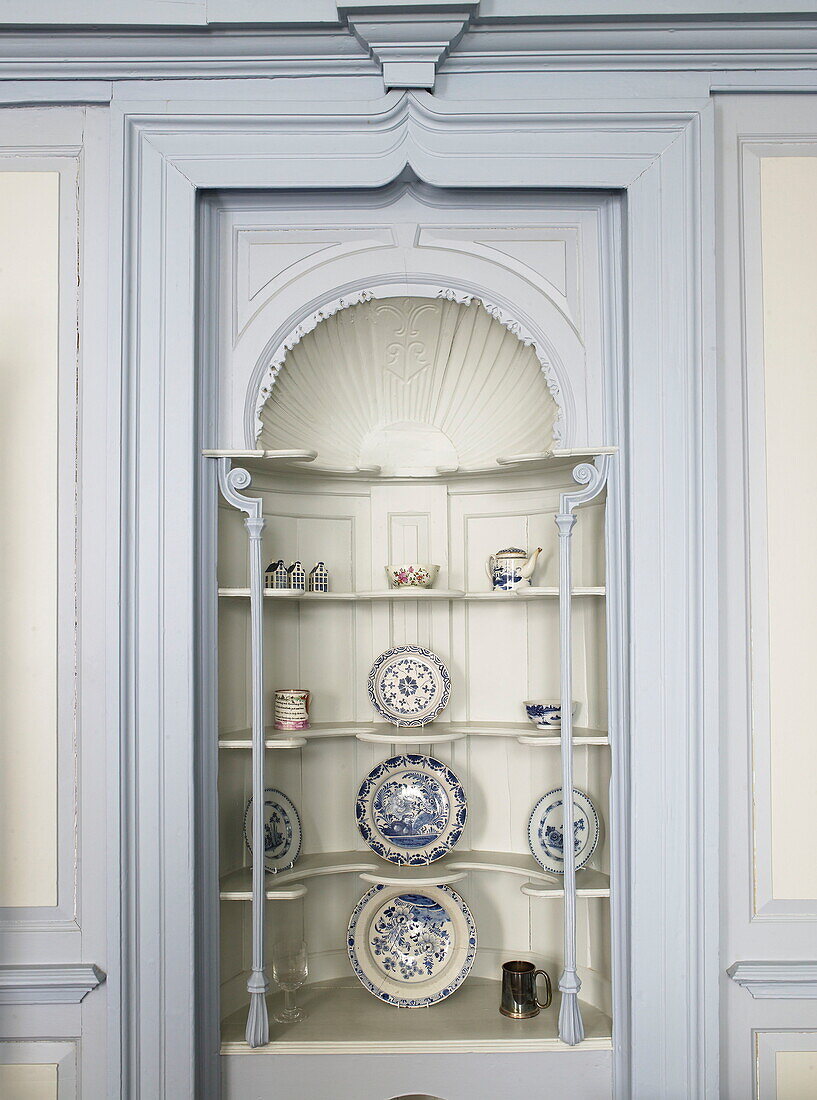 Decorative chinaware in alcove of Georgian townhouse in Laughame, Wales, UK