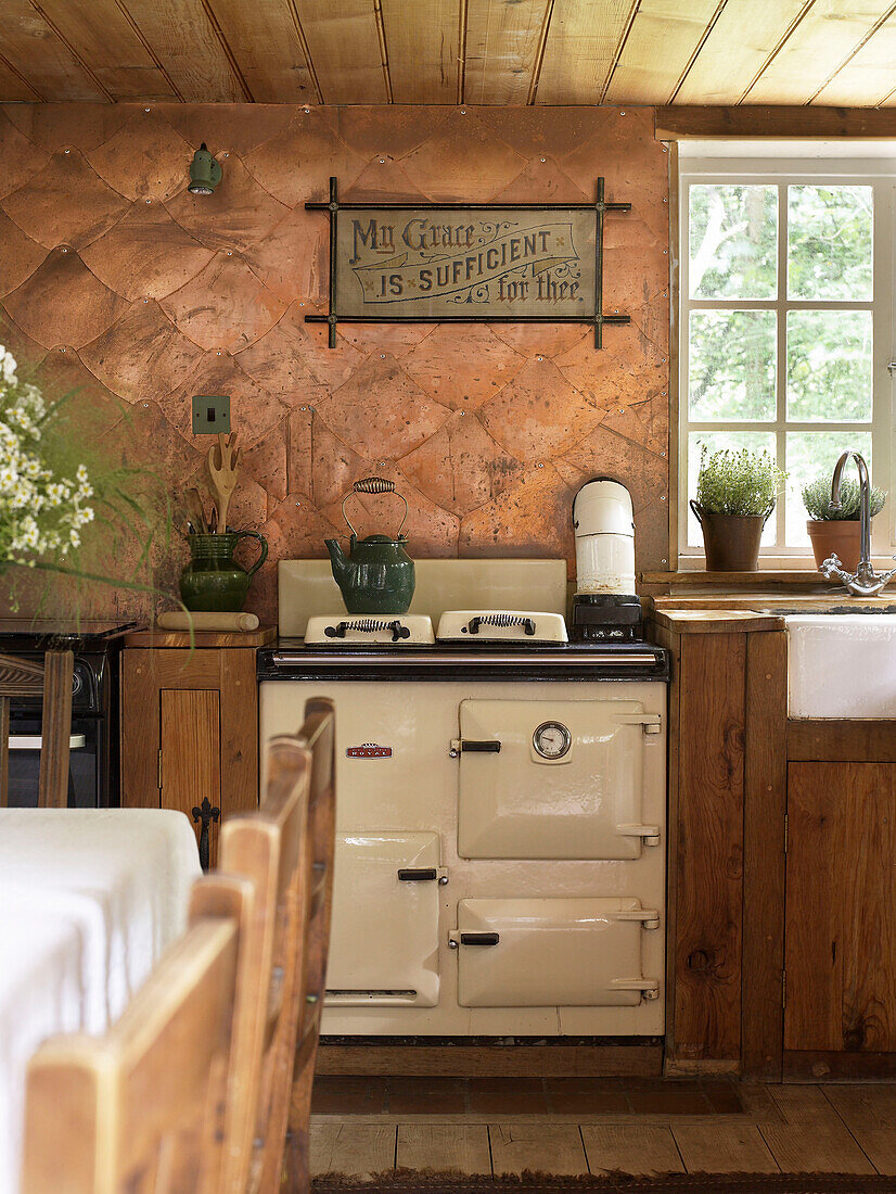 Kettle on hob of range oven in converted Shropshire chapel kitchen England, UK