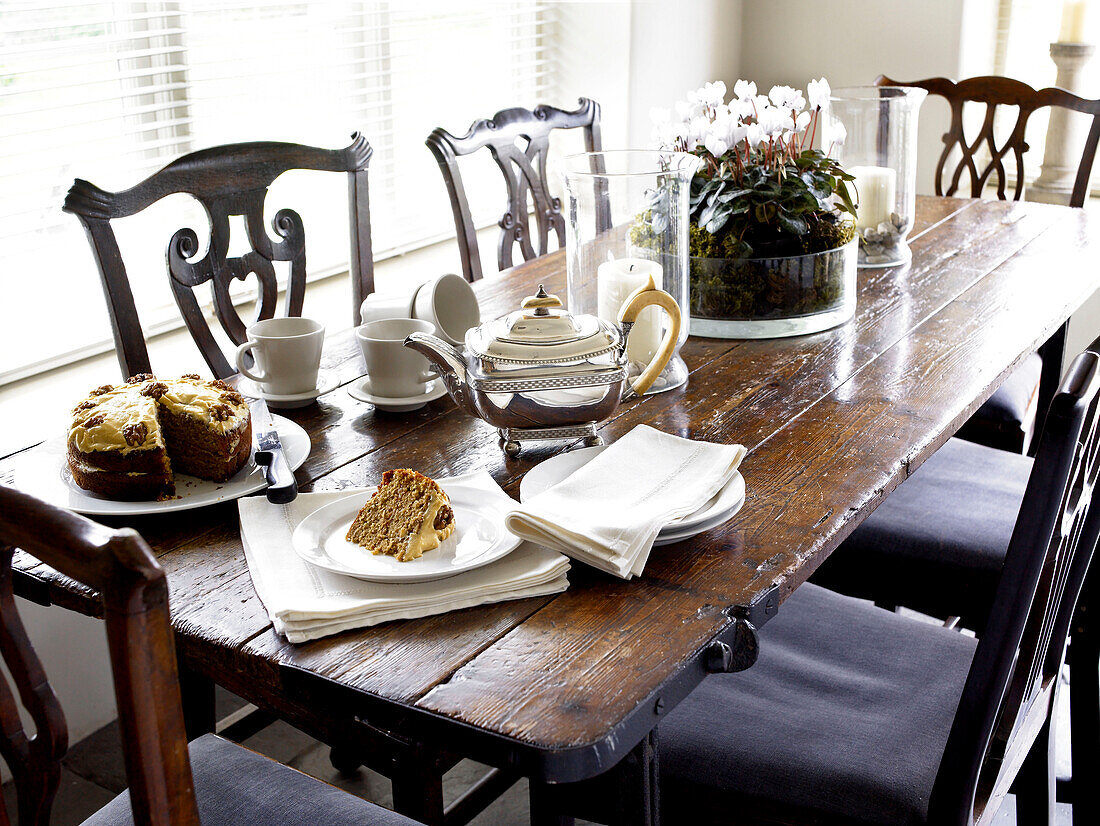 Tea and cake on antique dining table in Gloucestershire home, England, UK