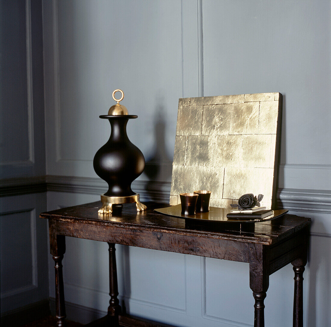 Vintage wooden sideboard with gold and black home wares