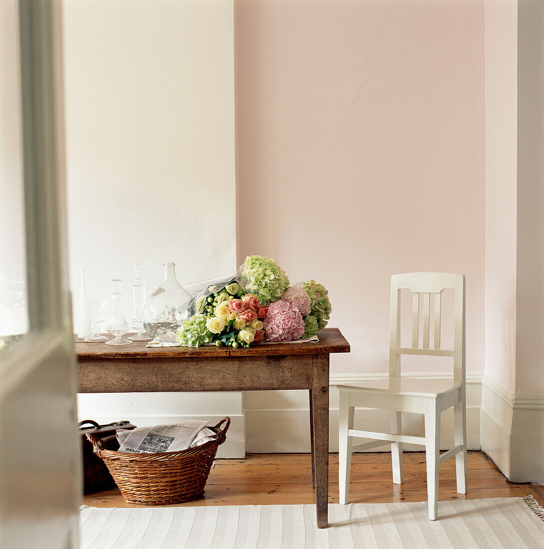 Dining room with large wooden table and a bouquet of fresh flowers