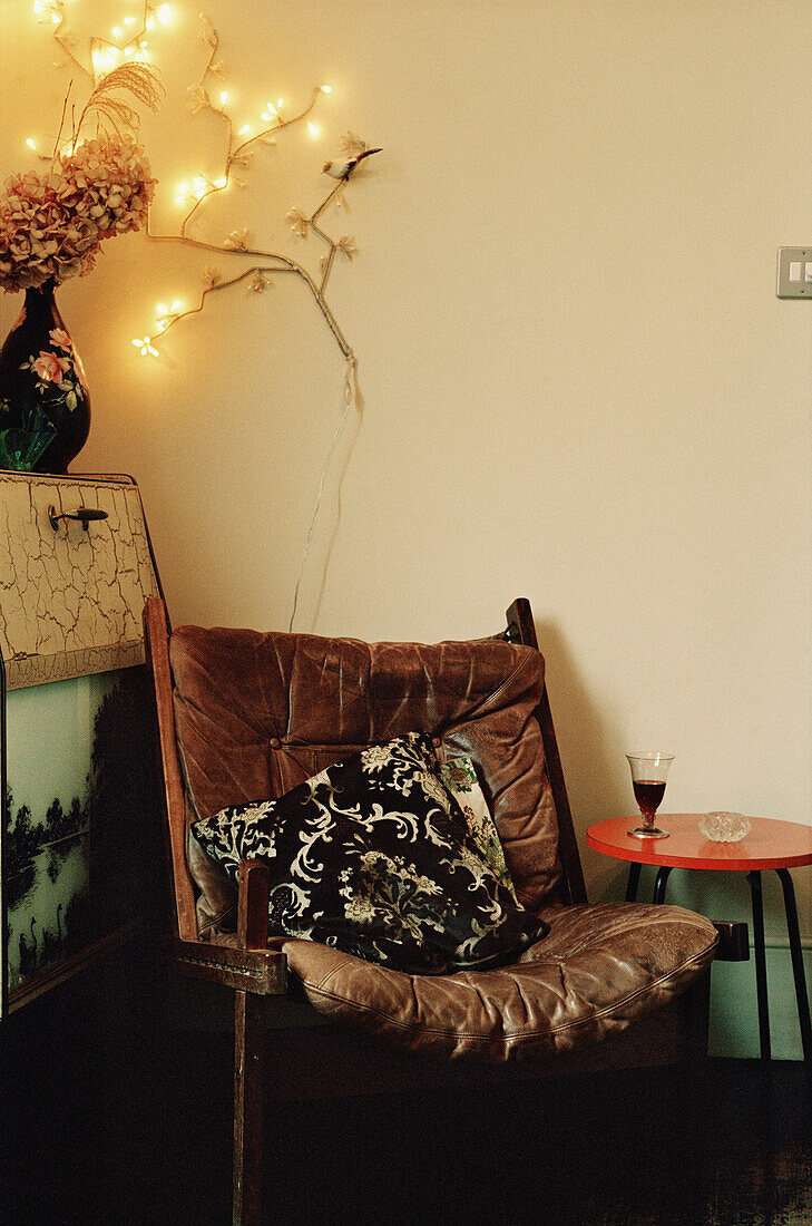 Worn leather chair in corner of living room