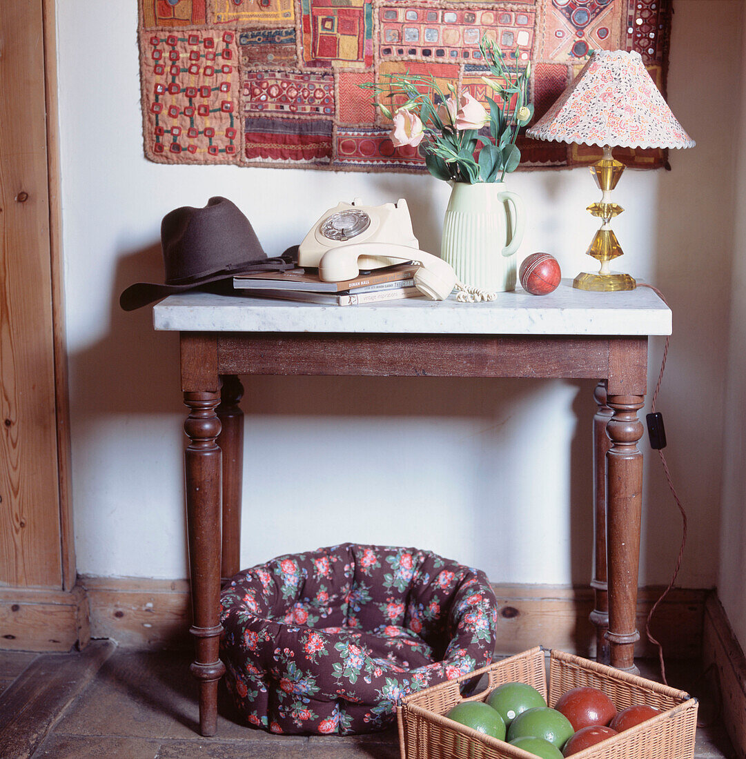 Hall table in period home with telephone and dog bed