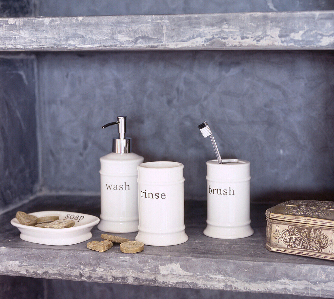 Concrete shelf containing toiletries in a bathroom