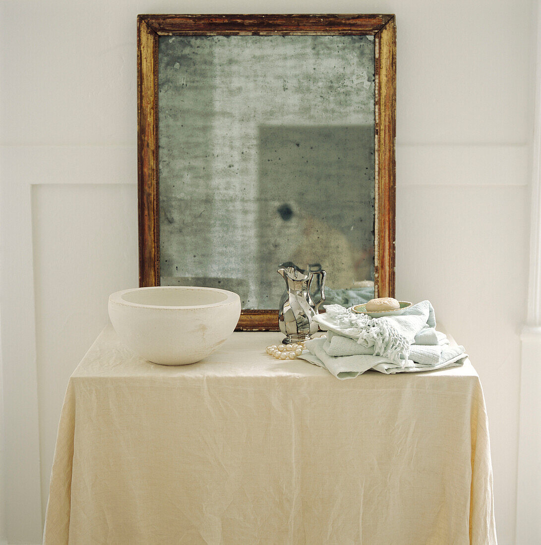 Bedroom dressing table with large vintage mirror and toiletries