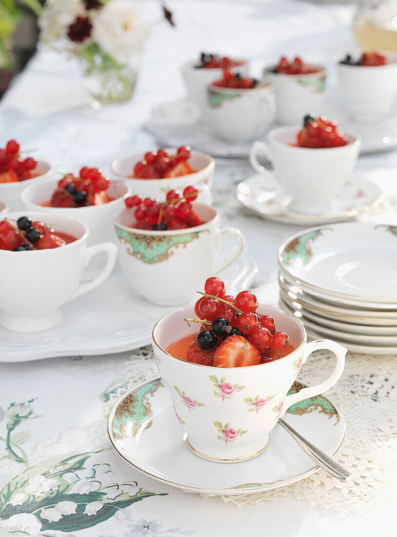 Summer berries served in china teacups and saucers Derwent Water, Cumbria, England UK