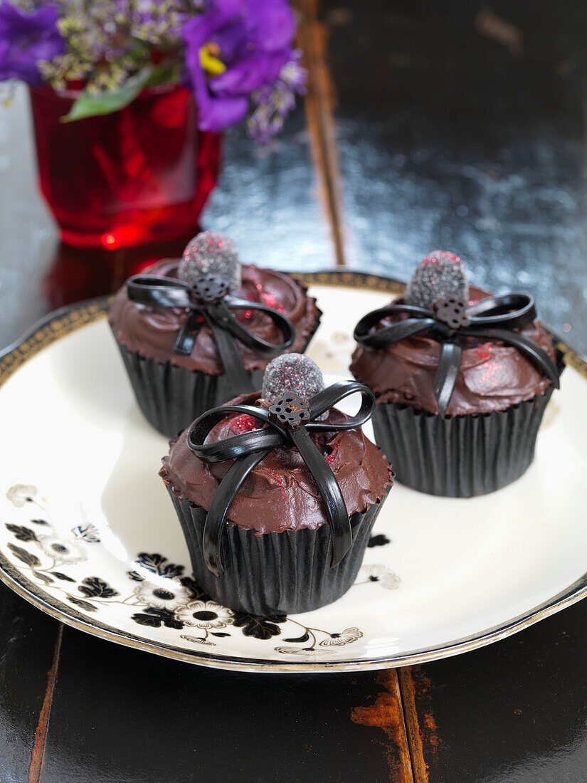 Chocolate cupcakes on floral patterned plate Brighton, East Sussex UK