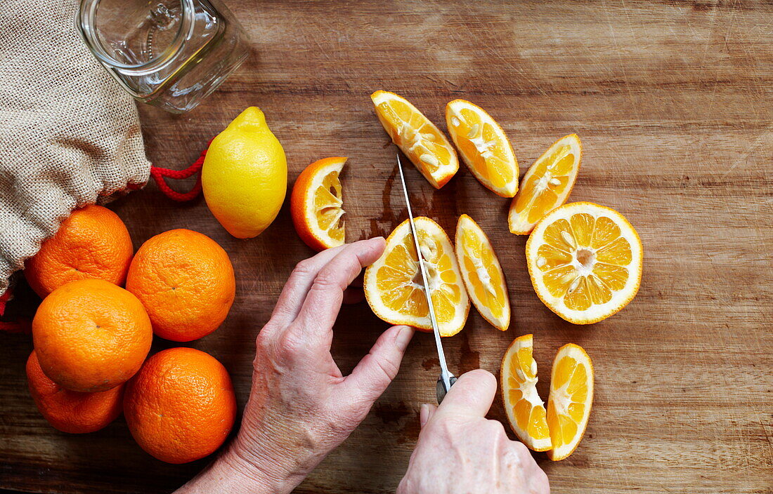 Man cutting oranges for marmalade, Southend-on-sea, Essex, England, UK