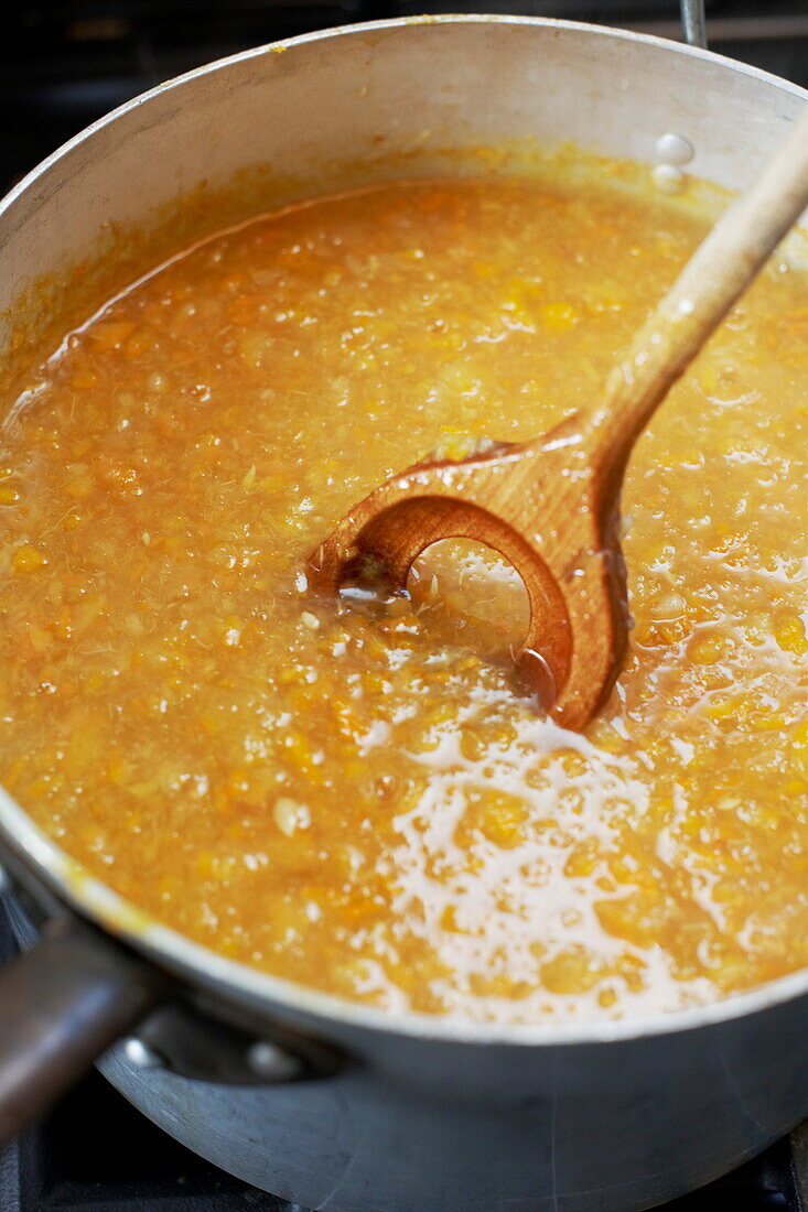 Mixing marmalade with a wooden spoon, Southend-on-sea, Essex, England, UK