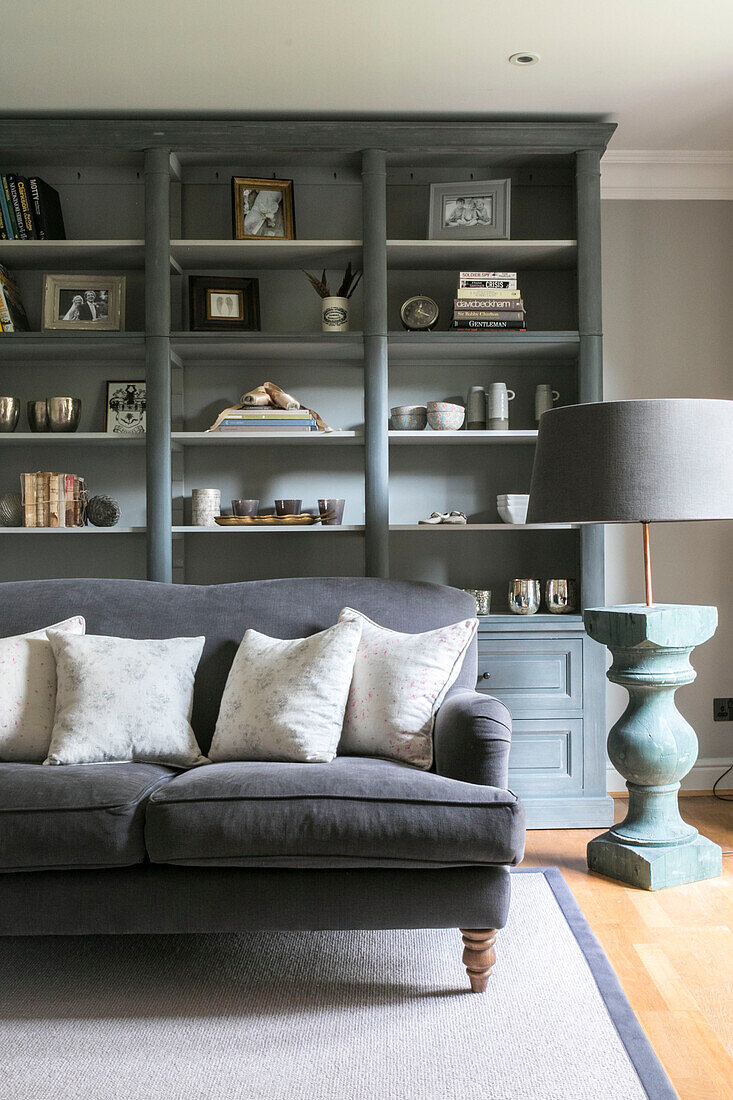 Grey sofa and bookcase in living room of Guildford townhouse Surrey UK