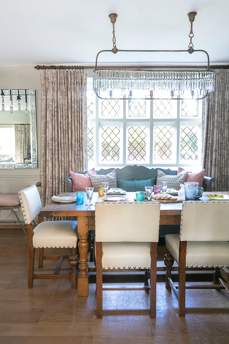 Oak wood table with reupholstered chair in Grade II listed Jacobean house Alton UK