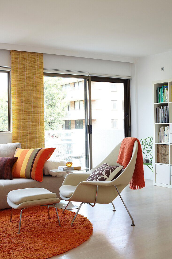 Armchair and footstool in living room of Sydney apartment Australia