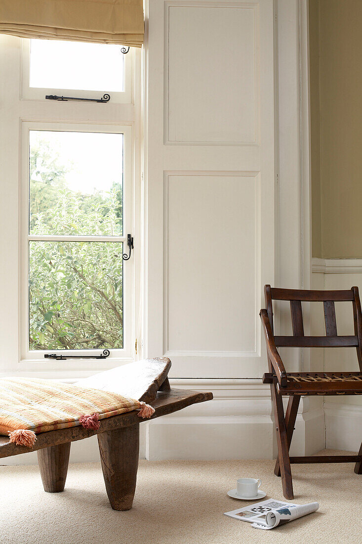 Wood seating at window of British apartment