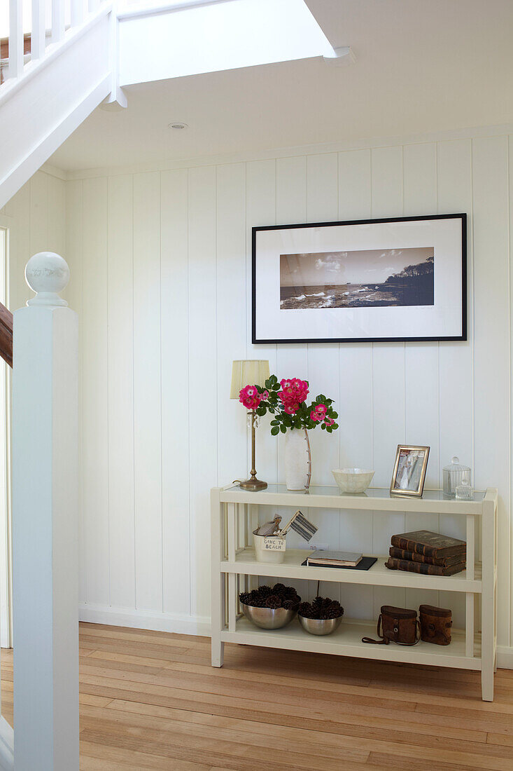 Entrance hallway shelving and artwork in Bembridge farmhouse, Isle of Wight, England, UK