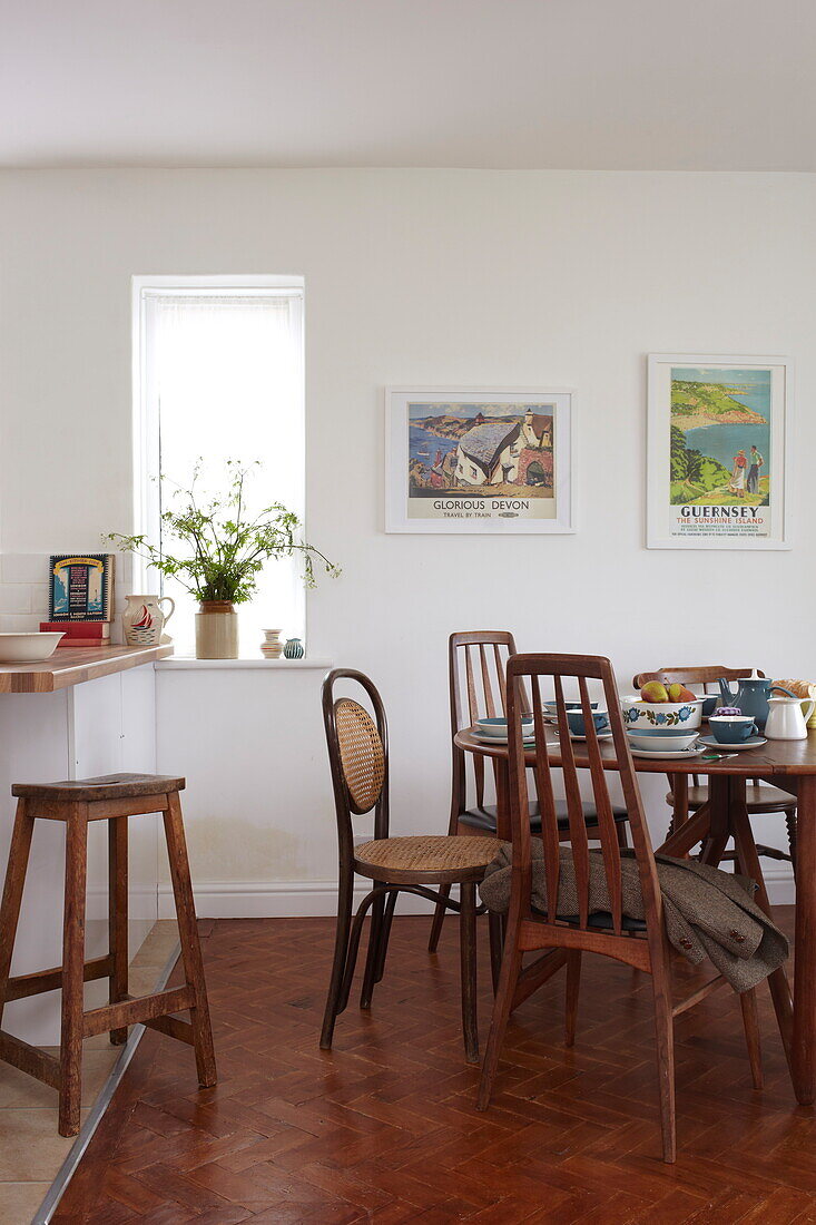 Retro style kitchen table and chairs with artwork in Bembridge home, Isle of Wight, UK