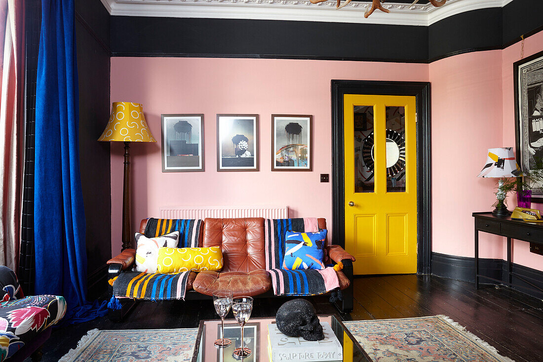 Bright yellow blue and pink living room in Hastings townhouse East Sussex England UK