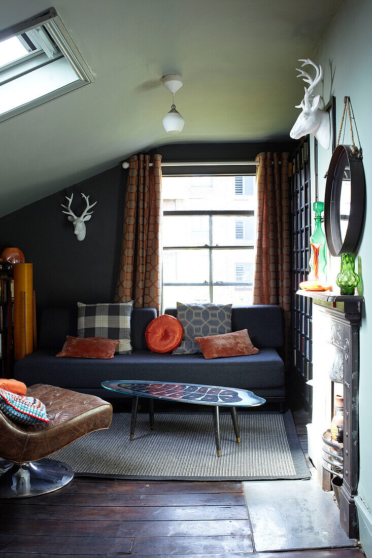 Brown leather armchair with sofa in London attic conversion, England, UK