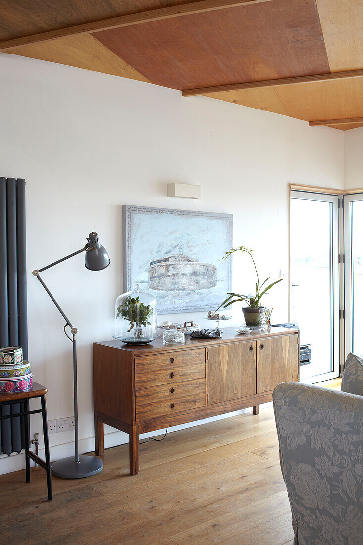 Wooden sideboard and desk lamp on Bembridge houseboat Isle of Wight, UK