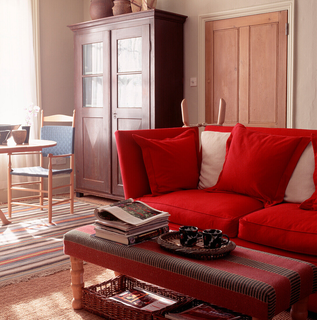 Bright red sofa and cushions in country style living room